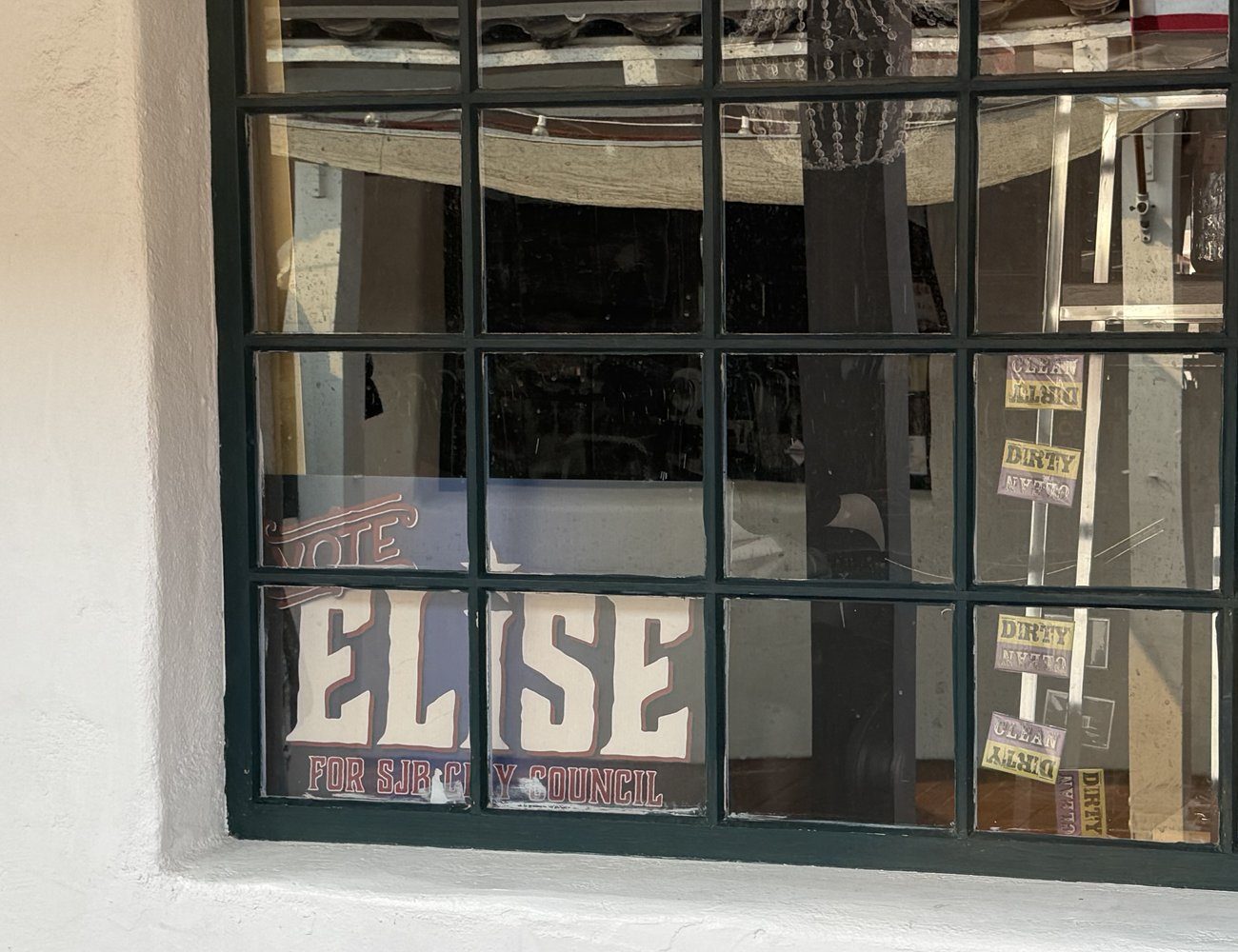 A Vote Elise for SJB City Council sign displayed in the window of a downtown San Juan Bautista storefront