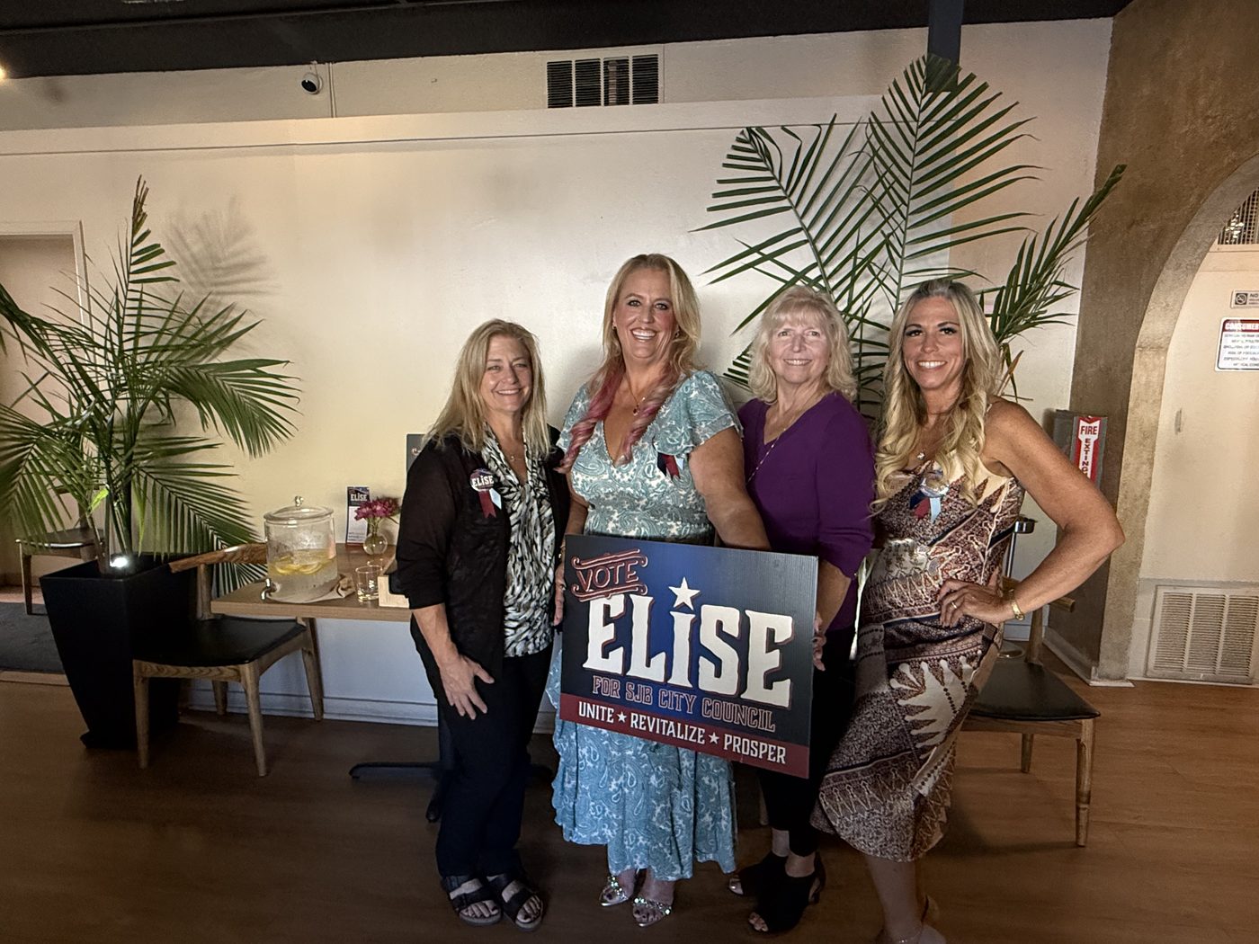 Four supporters holding a Vote Elise for SJB City Council sign