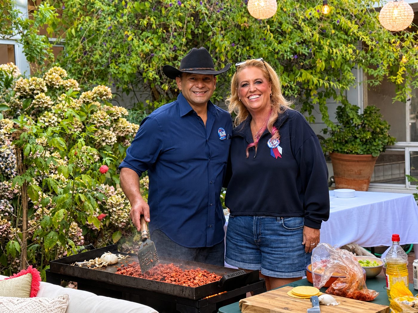 Elise Brentnall and a supporter at a backyard griddle, both wearing Vote Elise buttons