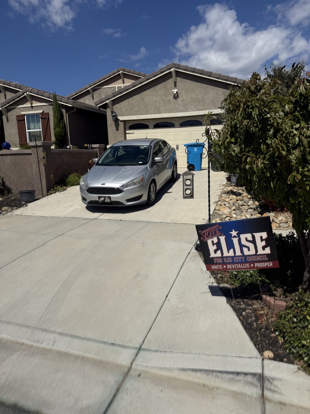 A Vote Elise yard sign at the end of a driveway